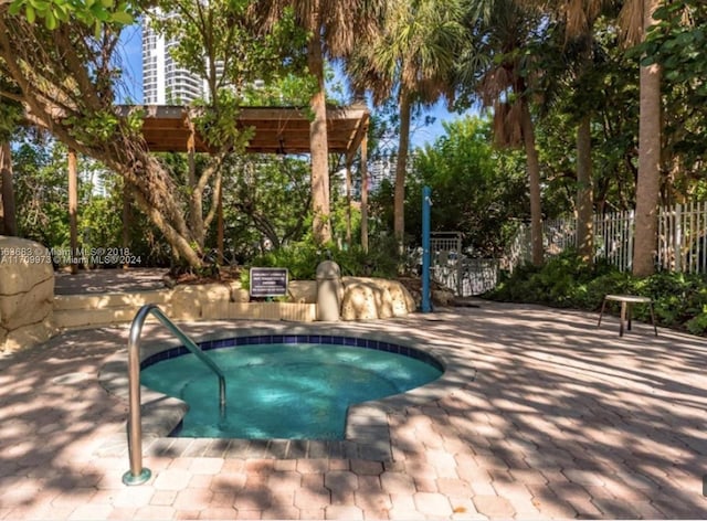 view of pool featuring a pergola, a hot tub, and a patio area