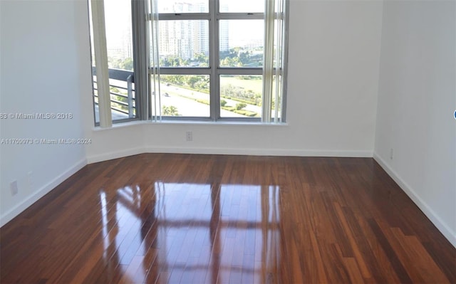 unfurnished room featuring dark hardwood / wood-style flooring