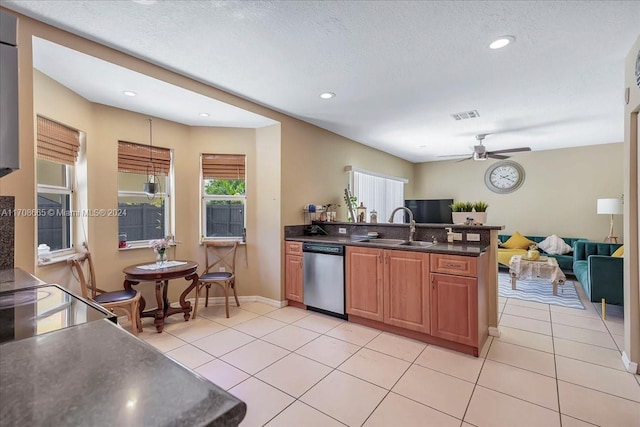 kitchen with ceiling fan, dishwasher, sink, kitchen peninsula, and light tile patterned flooring