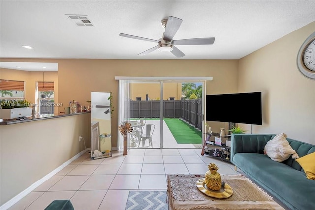 tiled living room with ceiling fan