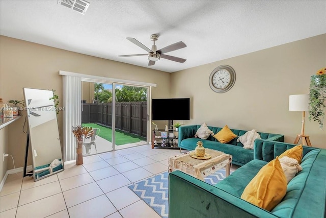 tiled living room featuring a textured ceiling and ceiling fan