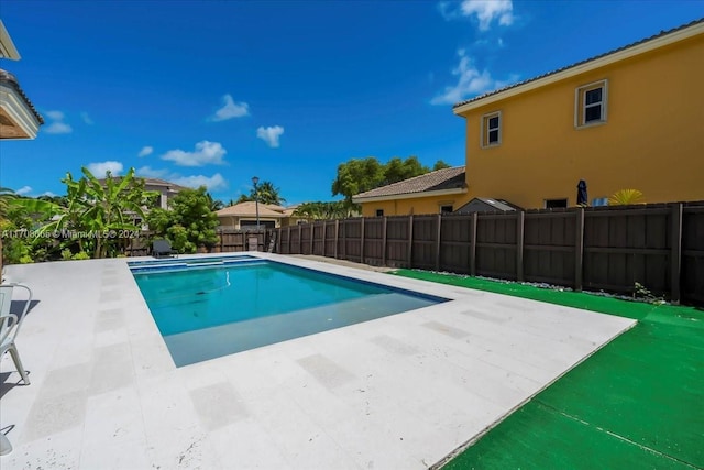 view of swimming pool with a patio