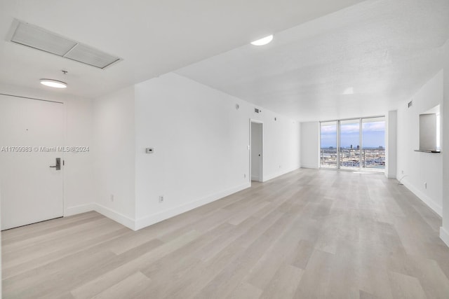 335 S Biscayne Blvd Unit 4109, Miami, FL 33131 - spare room with baseboards, light wood-style floors, and expansive windows