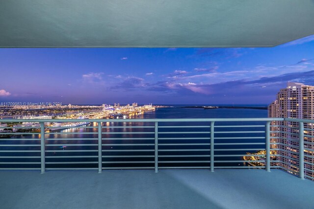 335 S Biscayne Blvd Unit 4109, Miami, FL 33131 - balcony at dusk with a water view and a view of city