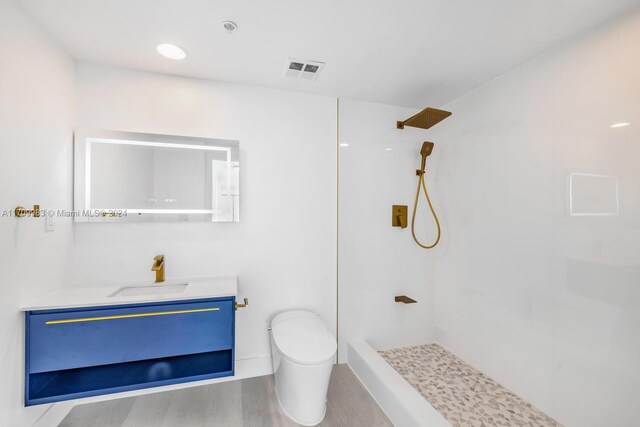 335 S Biscayne Blvd Unit 4109, Miami, FL 33131 - full bath with vanity, a walk in shower, toilet, visible vents, and wood finished floors