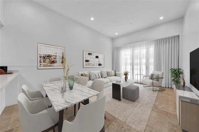 dining room with a towering ceiling