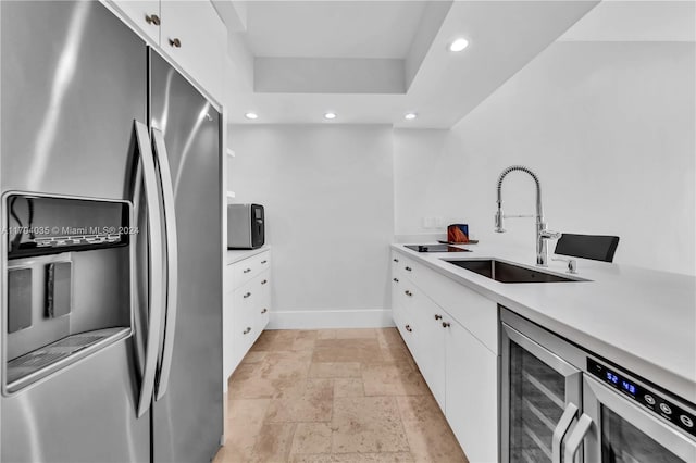 kitchen featuring white cabinets, stainless steel refrigerator with ice dispenser, wine cooler, and sink