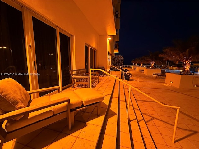 balcony at twilight featuring a patio