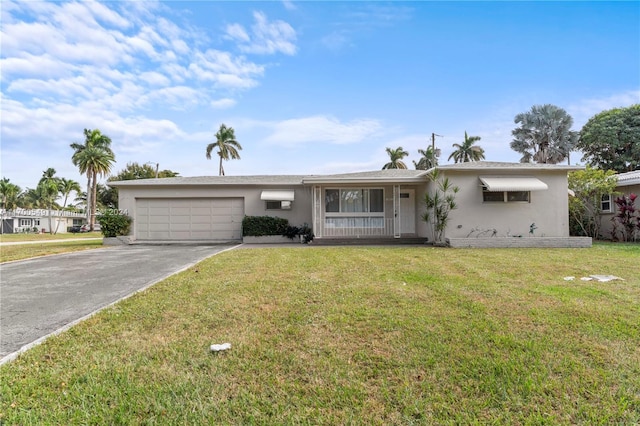 ranch-style house with a garage and a front lawn