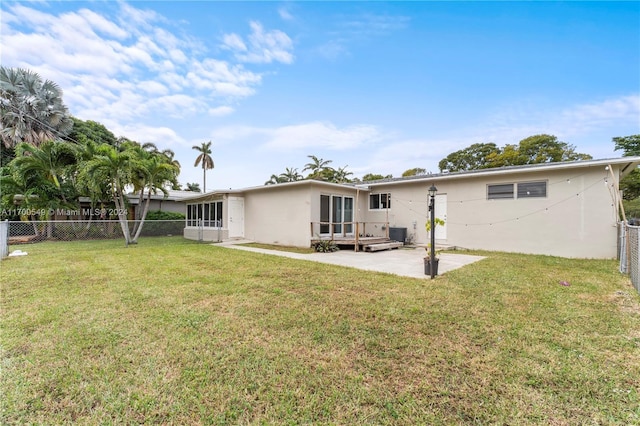 back of property with a lawn, cooling unit, and a patio