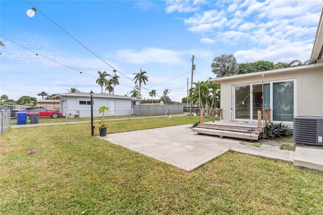 view of yard with central AC and a patio area