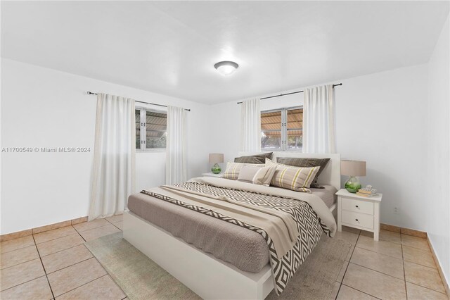 bedroom with light tile patterned floors