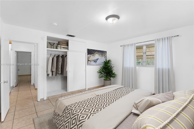 bedroom featuring light tile patterned floors and a closet