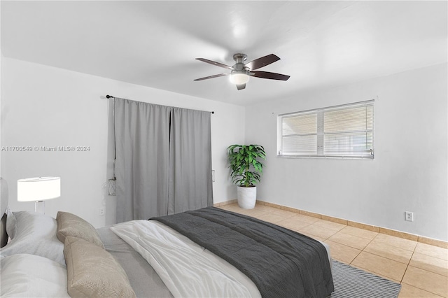 tiled bedroom featuring ceiling fan