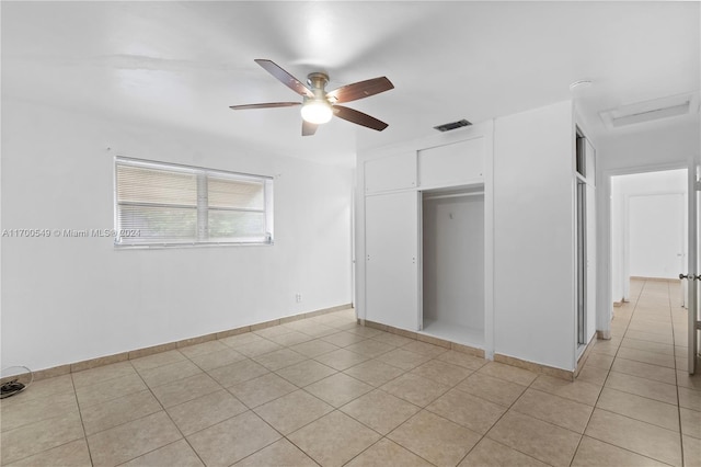 unfurnished bedroom with a closet, ceiling fan, and light tile patterned flooring