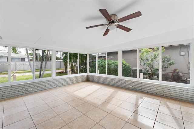 unfurnished sunroom with ceiling fan and lofted ceiling