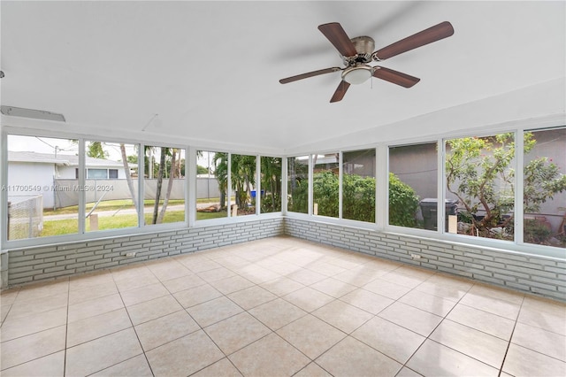 unfurnished sunroom with vaulted ceiling, ceiling fan, and a healthy amount of sunlight