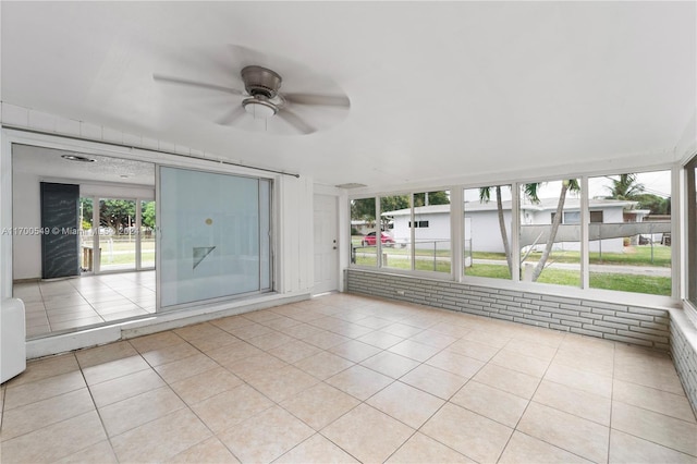 unfurnished sunroom with ceiling fan