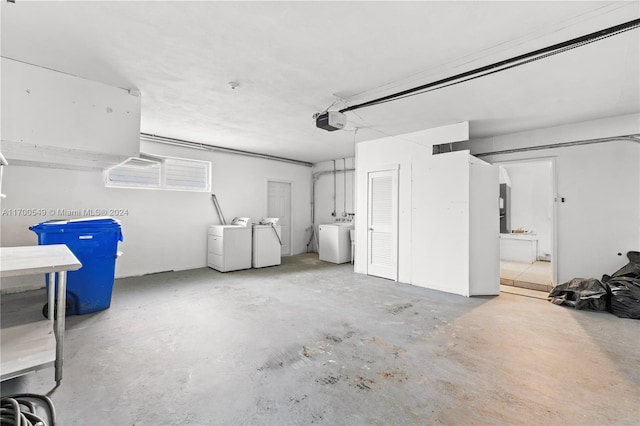 garage featuring washing machine and clothes dryer and a garage door opener