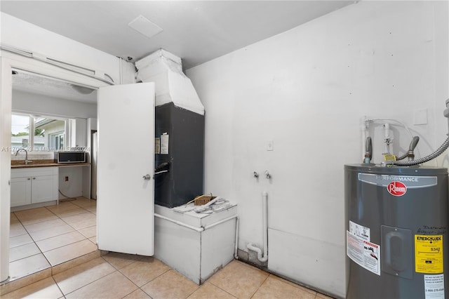 bathroom featuring electric water heater, tile patterned floors, and sink