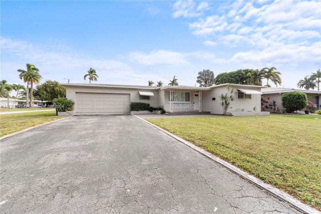 single story home featuring a front yard, a garage, and covered porch