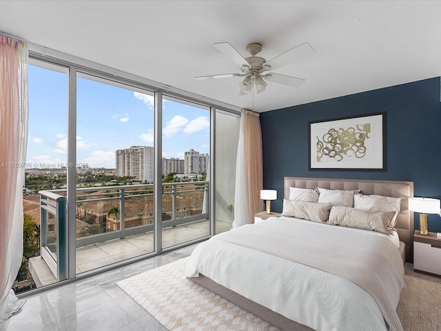 bedroom featuring expansive windows, access to exterior, and ceiling fan