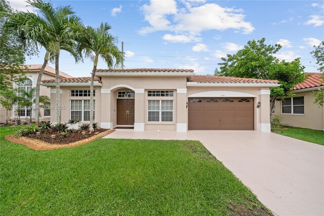 mediterranean / spanish-style house with a garage and a front lawn