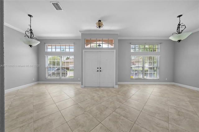 tiled entryway featuring ornamental molding