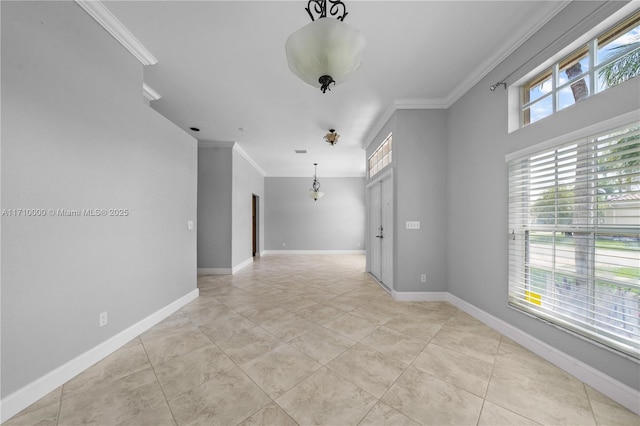 spare room with light tile patterned floors and crown molding