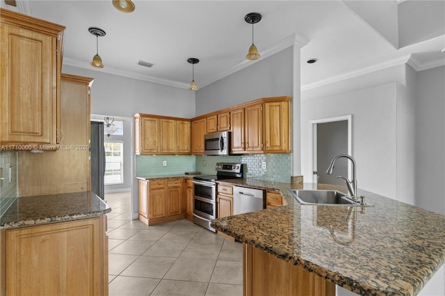 kitchen with hanging light fixtures, kitchen peninsula, sink, and stainless steel appliances