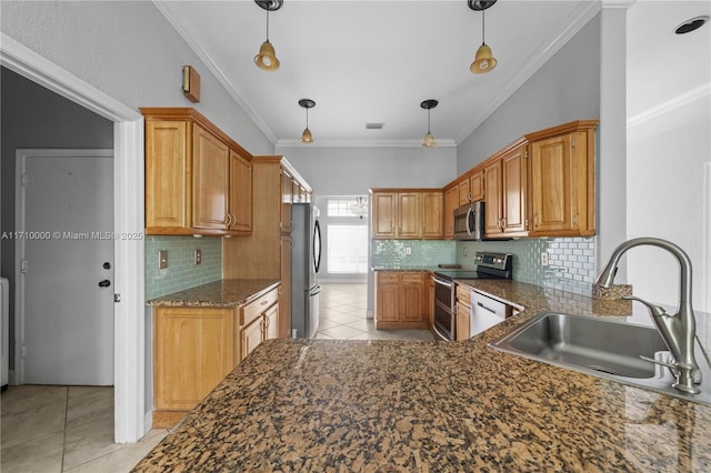 kitchen with hanging light fixtures, backsplash, appliances with stainless steel finishes, and sink