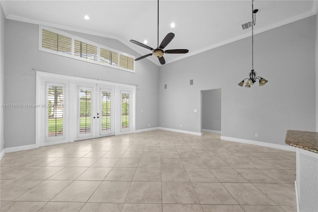 unfurnished living room with high vaulted ceiling, light tile patterned floors, ceiling fan with notable chandelier, and ornamental molding