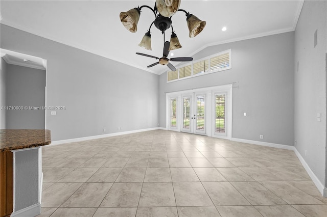 tiled spare room featuring ceiling fan with notable chandelier, ornamental molding, and lofted ceiling