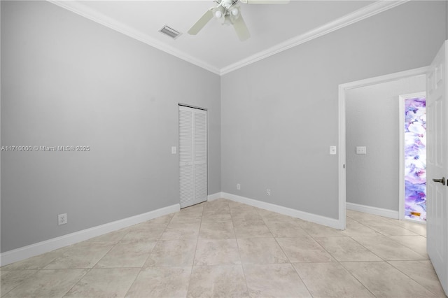 empty room featuring ceiling fan, light tile patterned floors, and crown molding