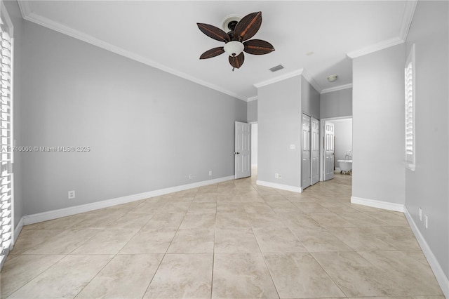 spare room featuring ceiling fan, light tile patterned floors, and crown molding