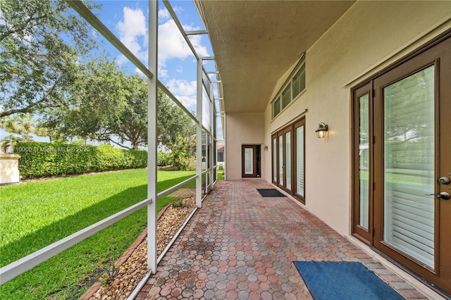 unfurnished sunroom with french doors