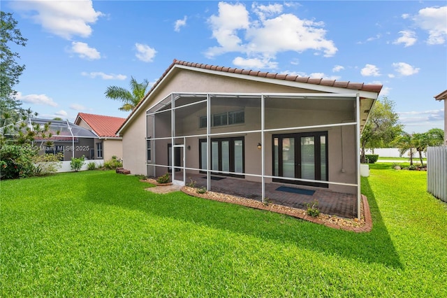 back of house featuring french doors and a yard