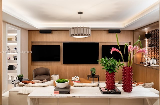 613 Almeria Ave, Coral Gables, FL 33134 - living room featuring a tray ceiling and wood walls