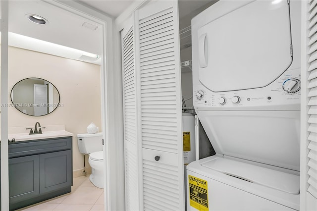 900 SW 125th Way Unit 304R, Pembroke Pines, FL 33027 - washroom with stacked washer / dryer, light tile patterned flooring, and water heater