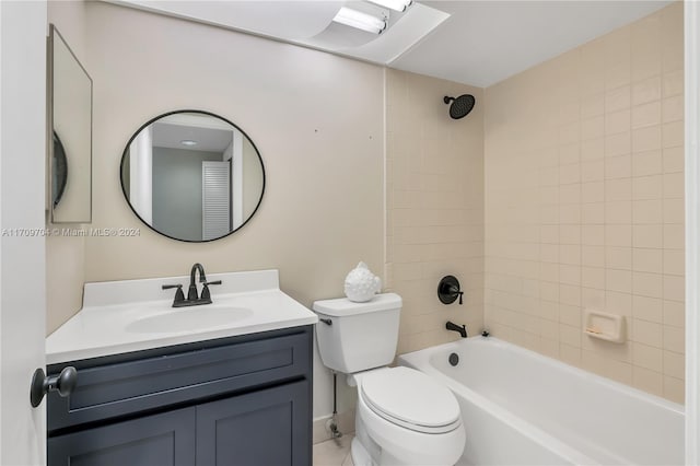 full bathroom featuring vanity, tiled shower / bath combo, and toilet