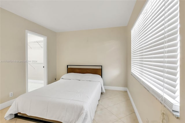 bedroom featuring multiple windows and light tile patterned flooring