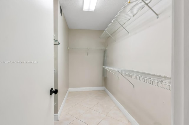 walk in closet featuring light tile patterned floors