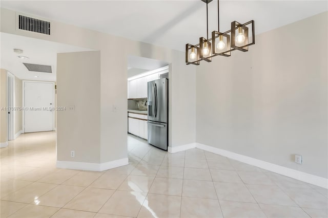 unfurnished dining area featuring light tile patterned flooring