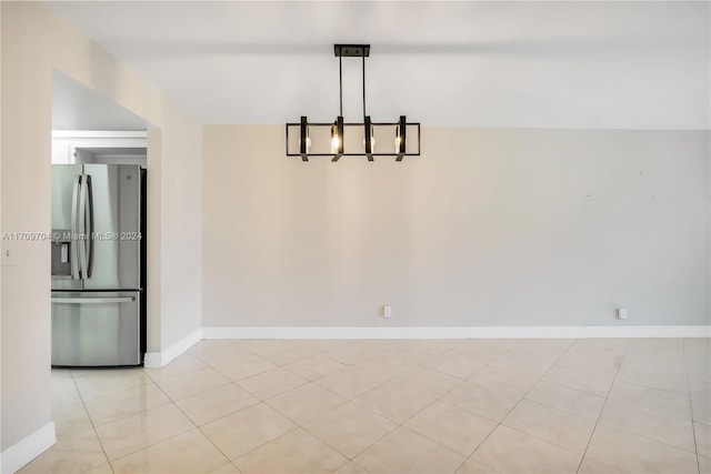 unfurnished dining area with light tile patterned floors and a chandelier