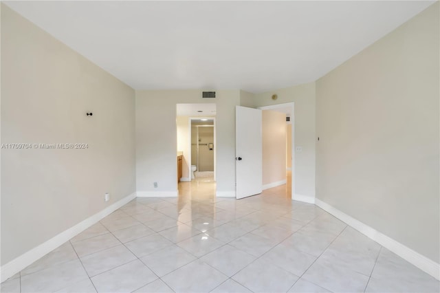 empty room with light tile patterned floors