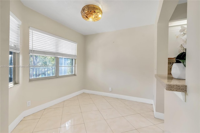 spare room featuring light tile patterned floors