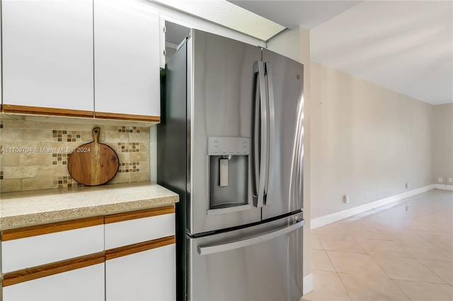 900 SW 125th Way Unit 304R, Pembroke Pines, FL 33027 - kitchen featuring stainless steel fridge with ice dispenser, white cabinets, backsplash, and light stone counters