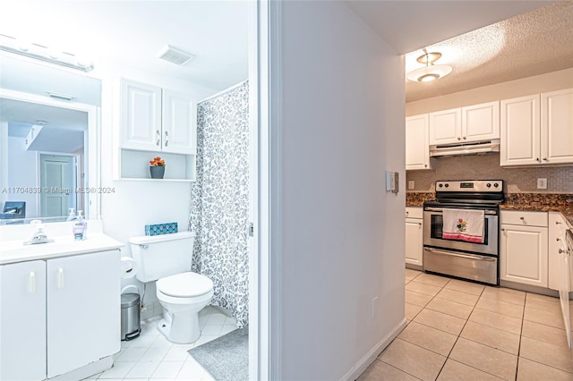 interior space featuring white cabinetry, sink, light tile patterned floors, a textured ceiling, and stainless steel range with electric cooktop