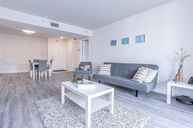 living room featuring a textured ceiling and hardwood / wood-style flooring