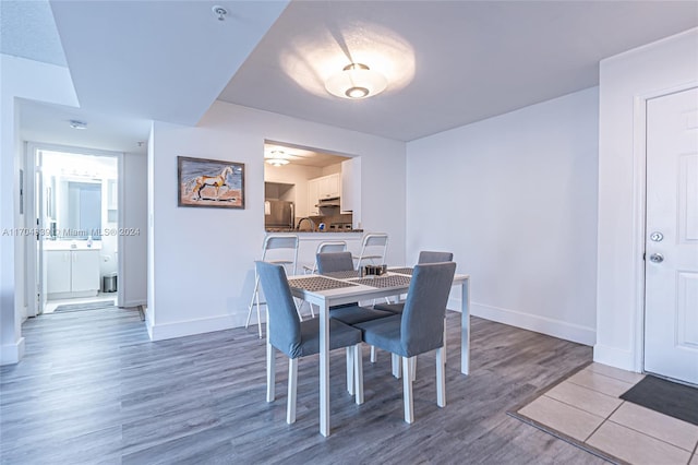 dining space featuring light hardwood / wood-style floors and ceiling fan